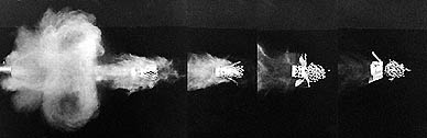 [Shotgun discharge showing casing peeling back exposing #6 pellets]